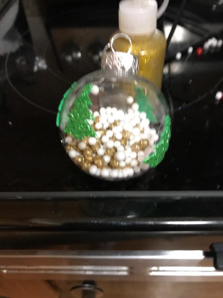 Decorated Clear and White Ornaments  - green tree stickers on a clear ornament with gold and white beads inside