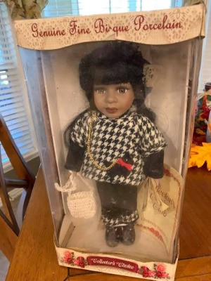 Value of a Collector's Choice Porcelain Doll - doll in box wearing a houndstooth jacket