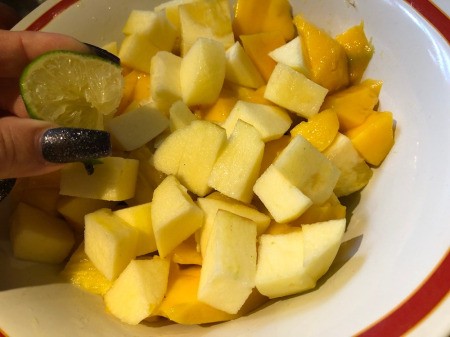squeezing lime juice on Fruit Salad