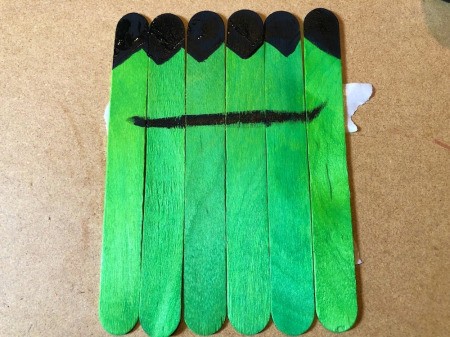 Halloween Craft Stick Puzzles - paint on a heavy brow line, allow to dry
