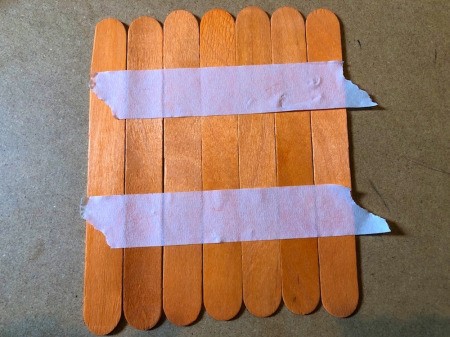 Halloween Craft Stick Puzzles - tape orange sticks together