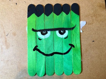 Halloween Craft Stick Puzzles - with black paint add pupils to eyes and a crooked smile