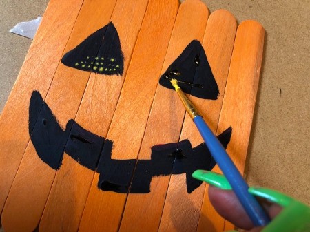 Halloween Craft Stick Puzzles - once dry, dot some yellow on the black areas to make it look illuminated