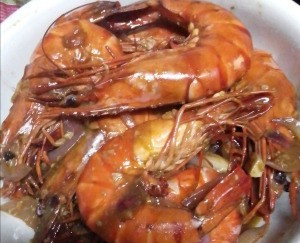 cooked unpeeled Garlic Butter Shrimp on plate