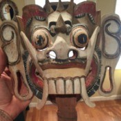 Wooden Mask Identification - painted wooden mask with large teeth and tusks