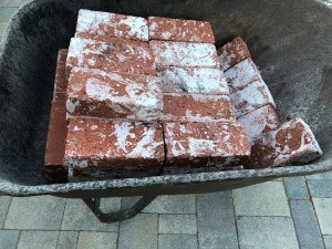 A wheelbarrow of bricks.