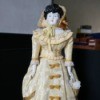 Identifying a Porcelain Doll - very old style porcelain doll in long beige dress with matching bonnet