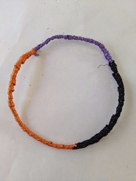 Hanging Halloween Themed Hoop Decoration - covered in orange, purple, and black