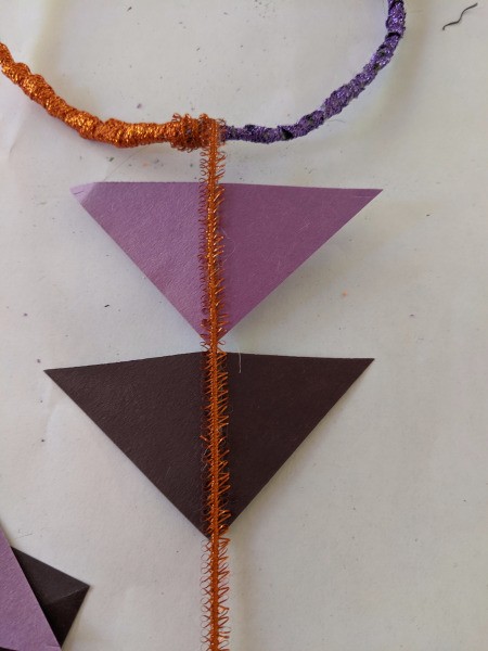 Hanging Halloween Themed Hoop Decoration - attach the paper triangles to the ribbon