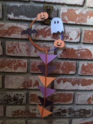 Hanging Halloween Themed Hoop Decoration - finished decoration hanging on brick fireplace