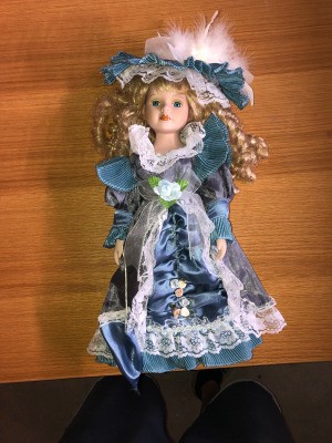 Value of a Cathay Porcelain Doll - doll wearing a blue satin dress and matching hat