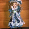 Value of a Cathay Porcelain Doll - doll wearing a blue satin dress and matching hat