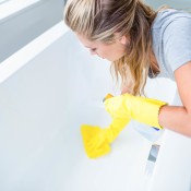 Woman Cleaning Bathtub