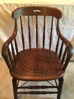 Identifying an Antique Chair - wooden arm chair with perforated wooden seat creating a star pattern and turned legs and rails between the legs