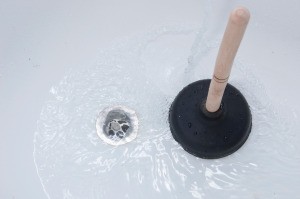 Plunger in a clogged bathtub