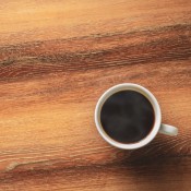 Hot coffee mug on wood table.