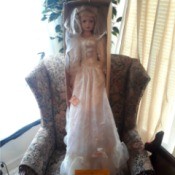 Finding the Value of Ashley Belle Dolls - tall doll wearing a long white dress standing in the box on a chair