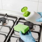 Cleaning gas burners with a sponge.