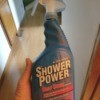 Buying Shower Power Cleaner - hand holding a bottle of Shower Power Cleaner
