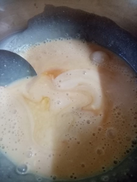 mixing custard & milk in pan