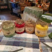 Crochet Thread Spool Pumpkins - the four finished pumpkins sitting on a tablecloth