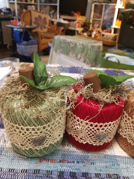 Crochet Thread Spool Pumpkins - moss attached to the top and corks glued in place followed by the leaves - two pumpkins shown