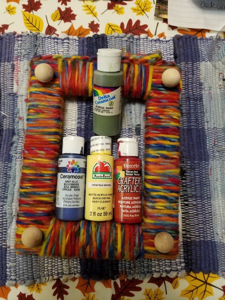Yarn Wrapped Frame - option to use painted wooden balls shown with unpainted balls and bottles of craft paint in the frame