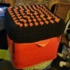 Recovering an Old Hassock - hassock top covered with a large black and orange granny square