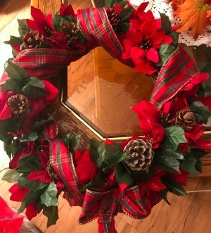 Poinsettia Wreath - finished wreath on edge of a table