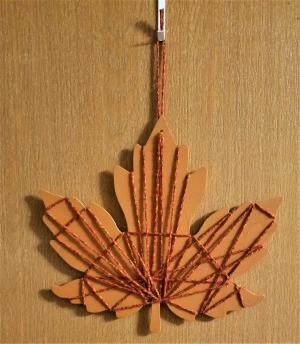 Yarn Embellished Wooden Maple Leaf - finished leaf hanging on the wall