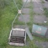 Value of a Ransones Antique Reel Lawn Mower - old grey mower with an X shaped handle