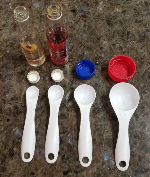 Measuring spoons next to caps that measure the same.