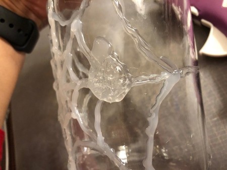 Hot Glue Spiderweb Jar - make a filled in circle of glue on the wed for the spider's body and then a smaller one for its head