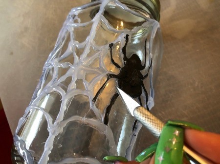 Hot Glue Spiderweb Jar - use knife to remove strings from spider