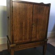 Value of a Brandt Cabinet - dark wood two door cabinet with a bottom shallow drawer