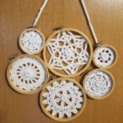 Embroidery Hoop Doily Wall Decoration - glue on the buttons and then arrange the hoops in a pleasing way and glue, add a chained hanger