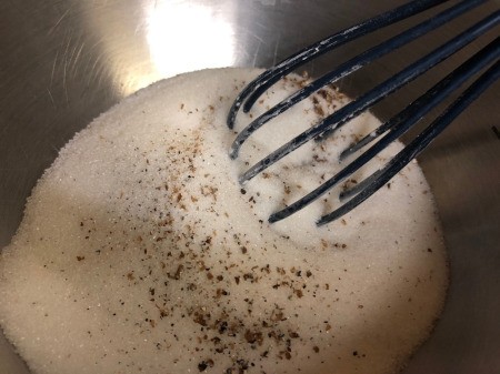 adding Cardamom powder to flour