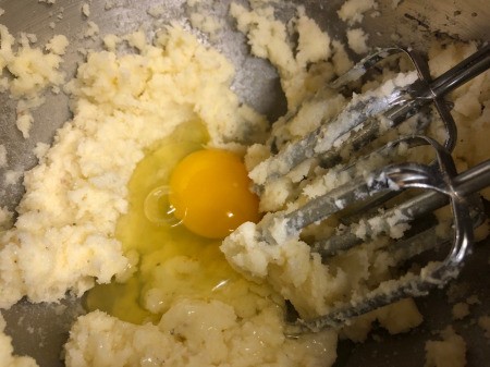 adding egg to flour