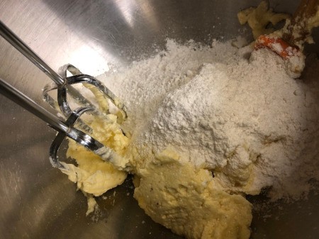 adding flour to batter