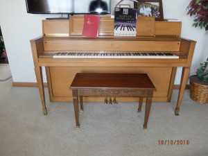 Value of a Story and Clark Upright Piano - light wood piano