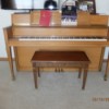Value of a Story and Clark Upright Piano - light wood piano