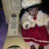 Value of a Collectible Memories Musical Doll - doll wearing a red dress and white fur hat and jacket, sitting next to its box