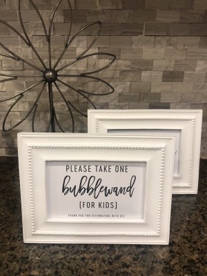 Two white frames being used at a wedding without glass.