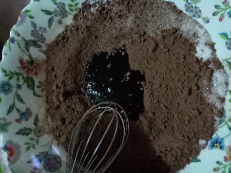 adding oil to cocoa & sugar