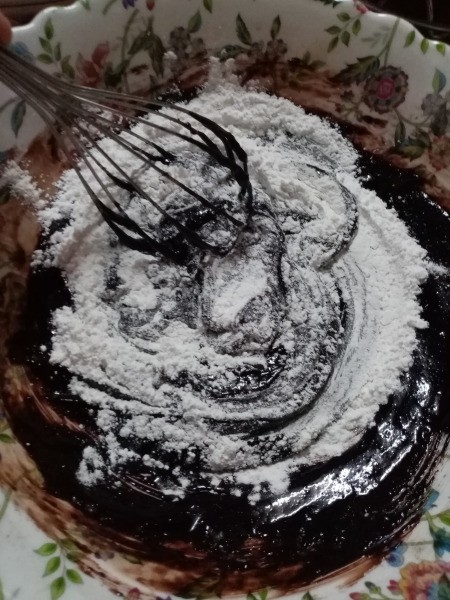 adding dry ingredients to cocoa mix