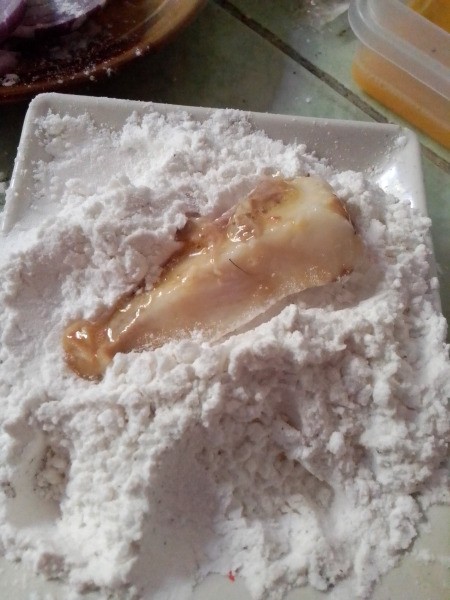 dipping egged pork in flour