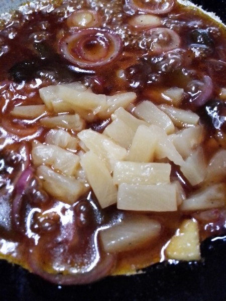 adding pineapple bits to sauce