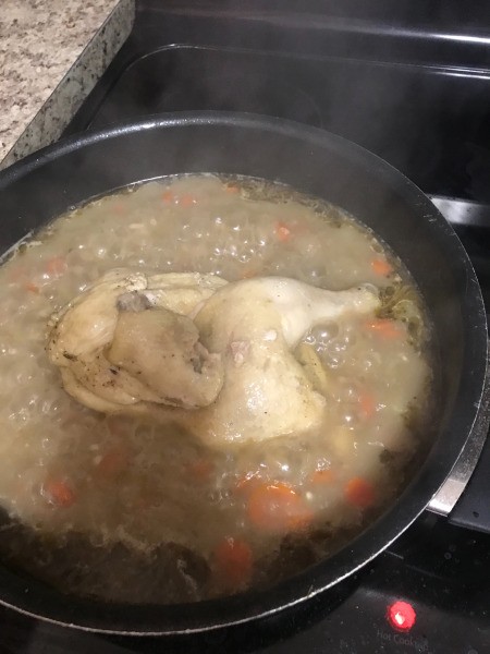 Chicken in pan with broth