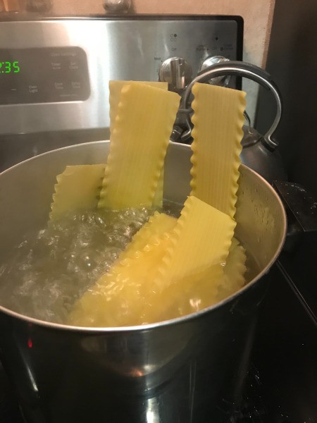 Lasagna in pan of boiling water