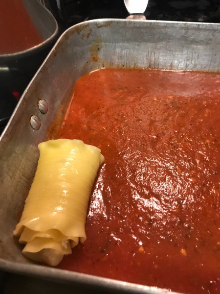 rolled up Lasagna noodles in sauce
